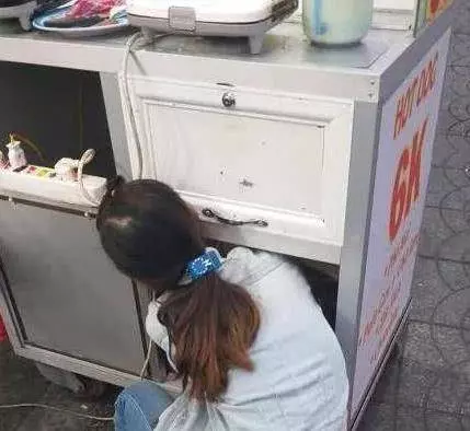 母親忙著賣食物賺生計,忙不過來的時候就會將嬰兒放進小吃車下面的櫃子裡,引網友爭議!