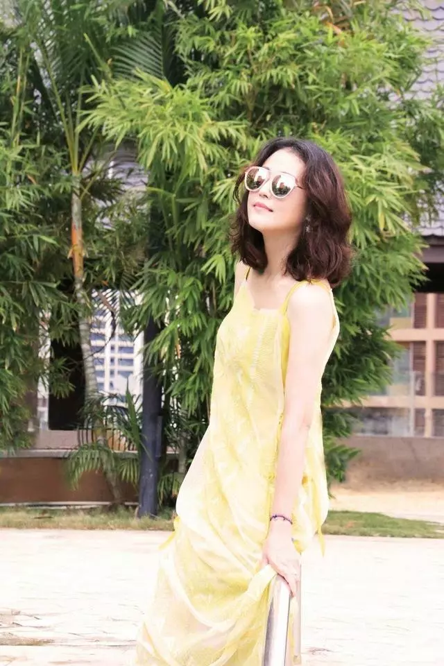 周海媚哪像52歲!一襲黃色弔帶裙太減齡,半扎丸子頭更有少女感~