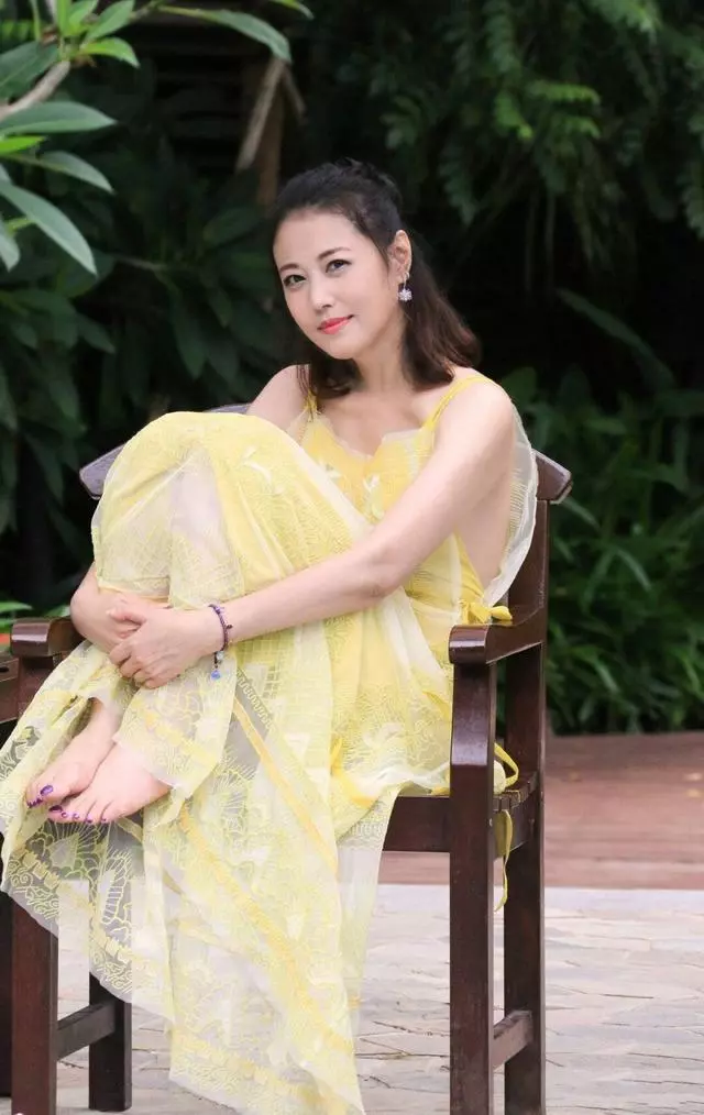 周海媚哪像52歲!一襲黃色弔帶裙太減齡,半扎丸子頭更有少女感~